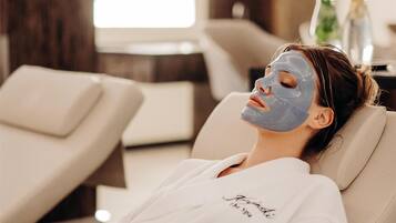 A person lying on a massage chair in a spa setting.