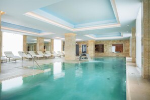 Indoor pool, open 9:00 AM to 9:00 PM, pool loungers