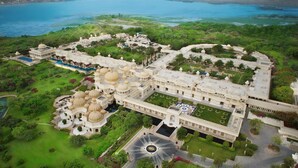 An aerial view of a large, historic building with multiple domes, extensive gardens, and a large pool. - The Oberoi Udaivilas, Udaipur (Udaipur)