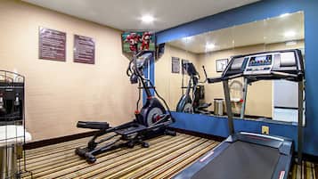 A hotel fitness center with treadmills, elliptical machines, and exercise bikes.