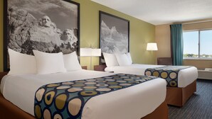 A hotel room with two beds, a large window, and a view of mountains. - Super 8 by Wyndham Sioux Falls (Sioux Falls)