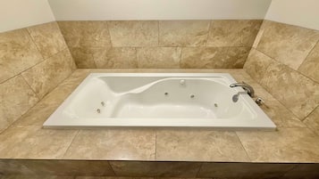 A rectangular bathtub with a single faucet and no visible controls.