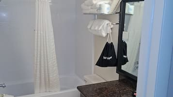 A bathroom with a bathtub, toilet, and sink.