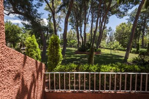 Surrounded by lush trees and a manicured lawn, this serene setting offers a peaceful escape.