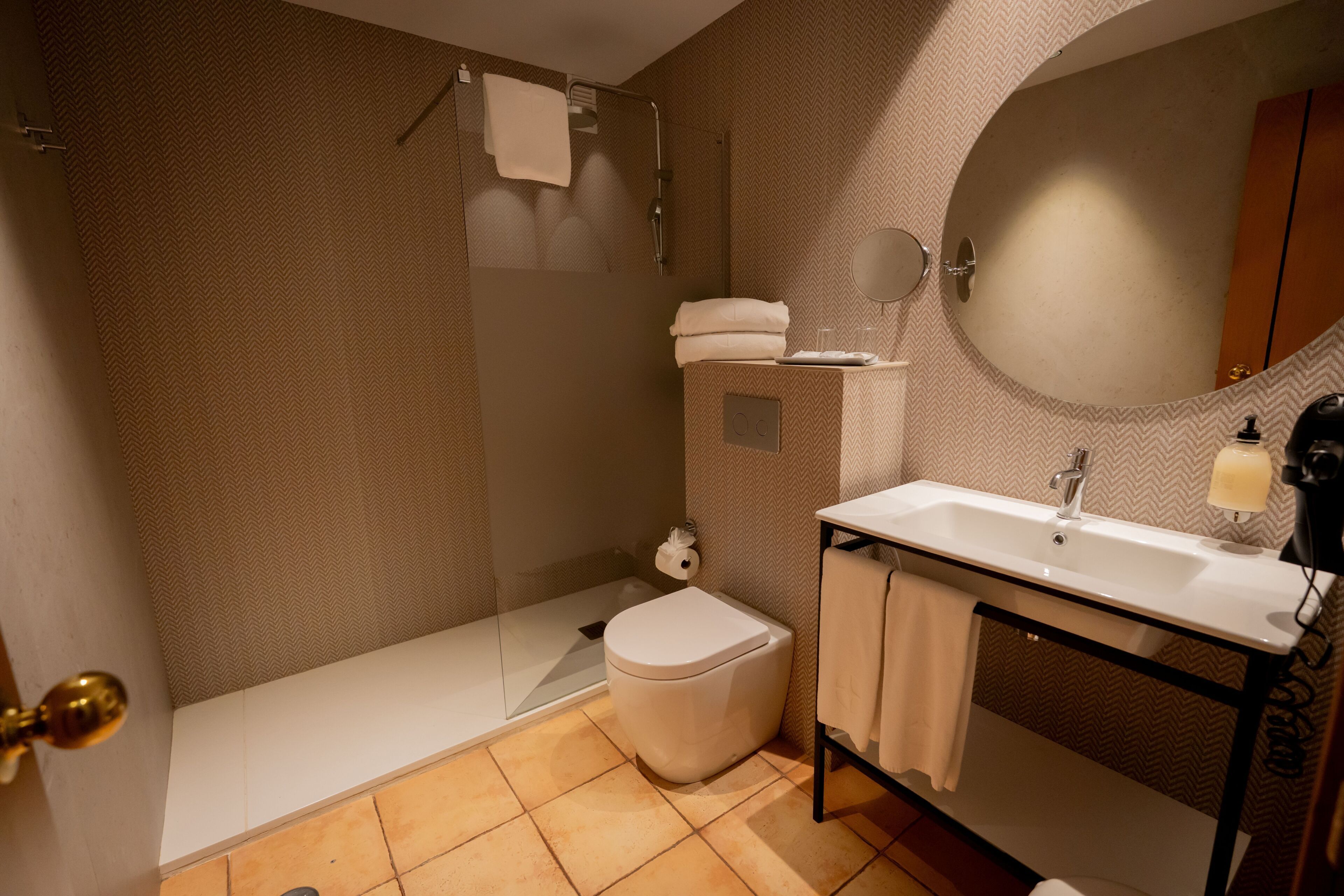A bathroom with a bathtub, toilet, sink, and mirror.