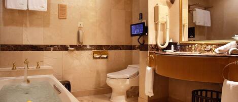 A bathroom with a bathtub, toilet, and sink.