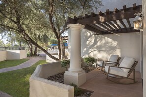 A patio area with a pergola, seating, and a small garden. - The Scottsdale Resort and Spa, Curio Collection by Hilton (Scottsdale)