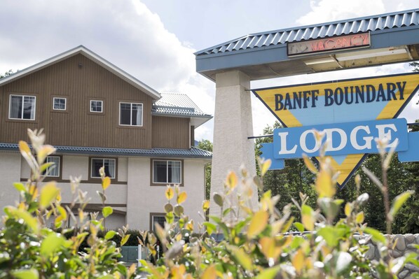 Welcome to Banff Boundary Lodge, featuring a modern design with a flat roof and multiple windows.