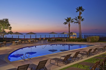 2 outdoor pools, pool umbrellas, sun loungers at Carlsbad Seapointe Resort
