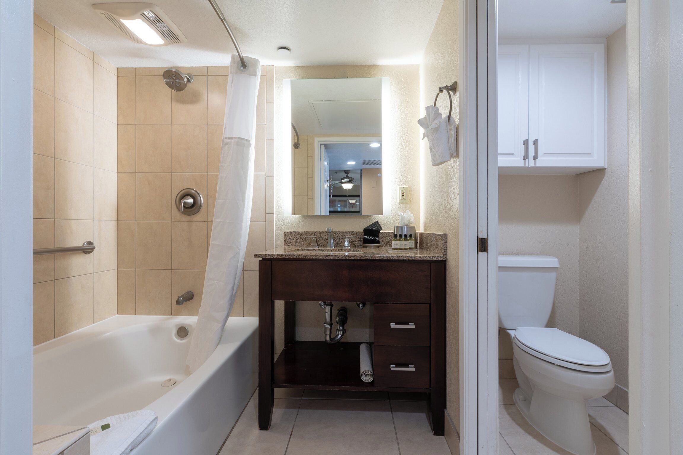 A bathroom with a bathtub, a sink, and a toilet.