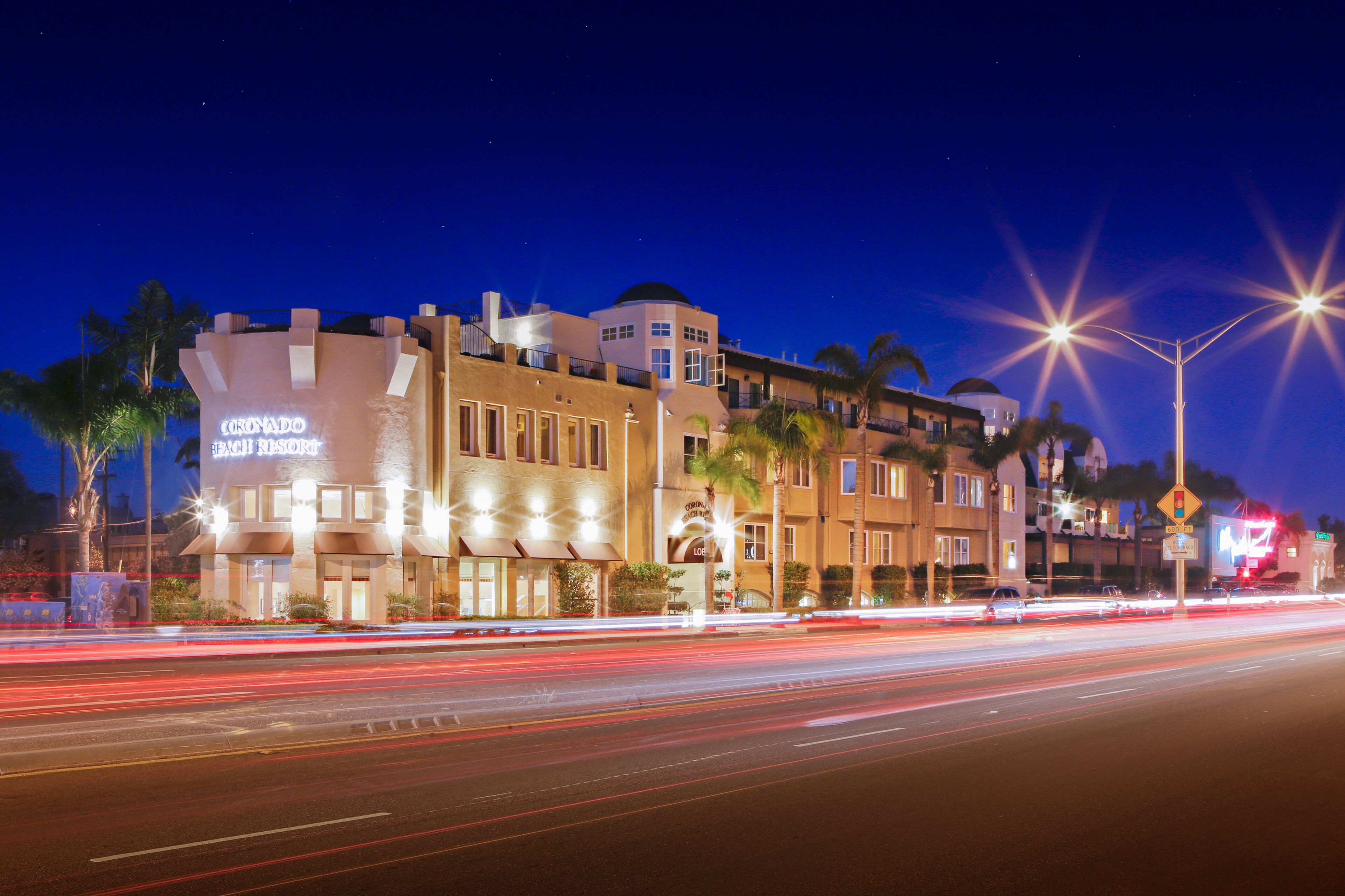 A hotel with a modern architectural design, featuring multiple stories and a prominent sign.