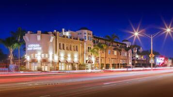 A hotel with a modern architectural design, featuring multiple stories and a prominent sign.