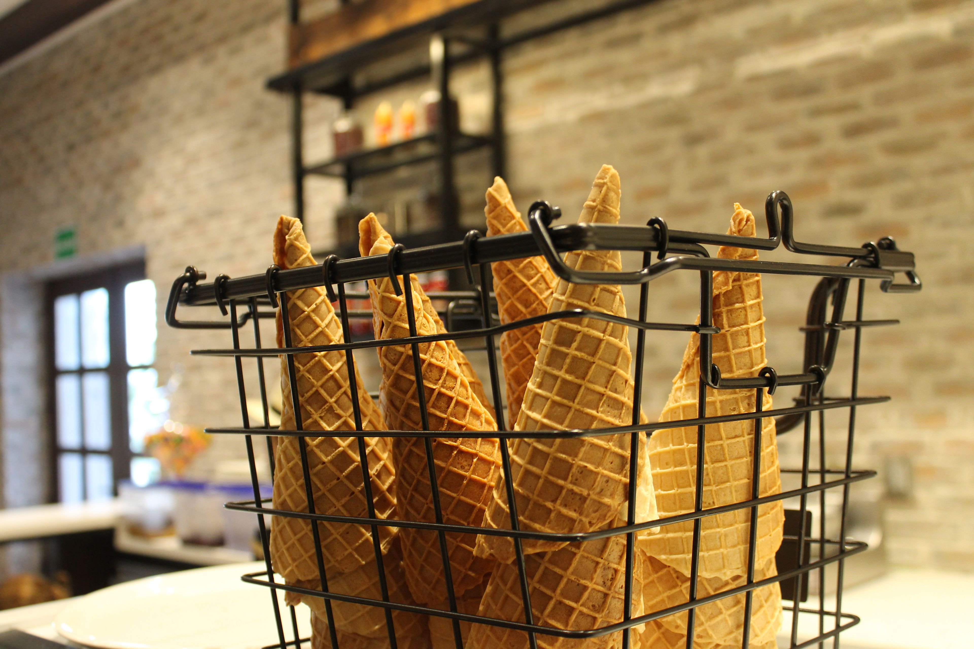 A waffle cone rack with several waffle cones.