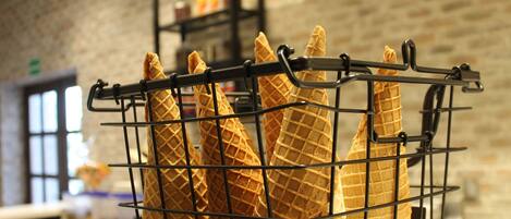 A waffle cone rack with several waffle cones.
