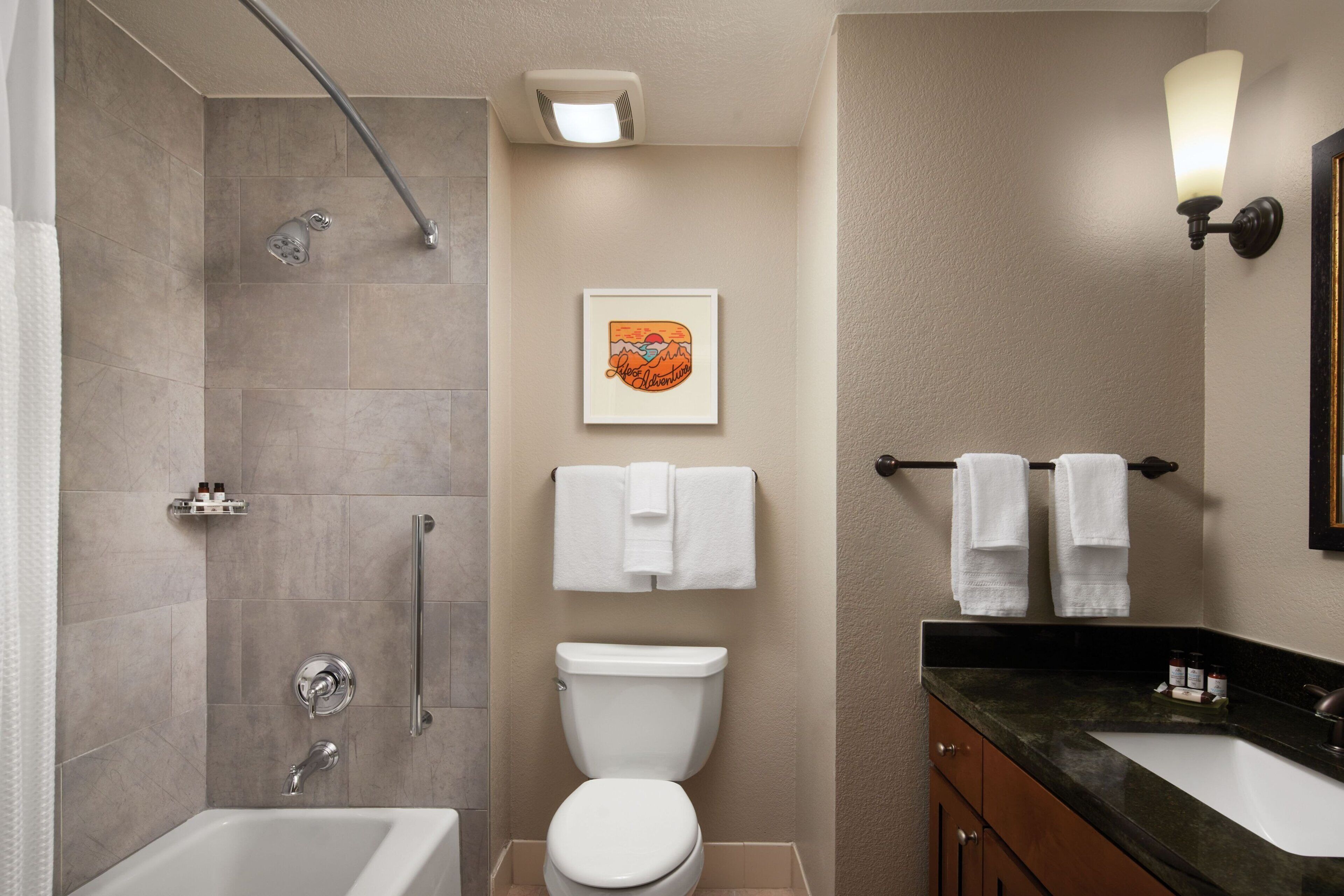 separate bathtub and shower, hair dryer, towels