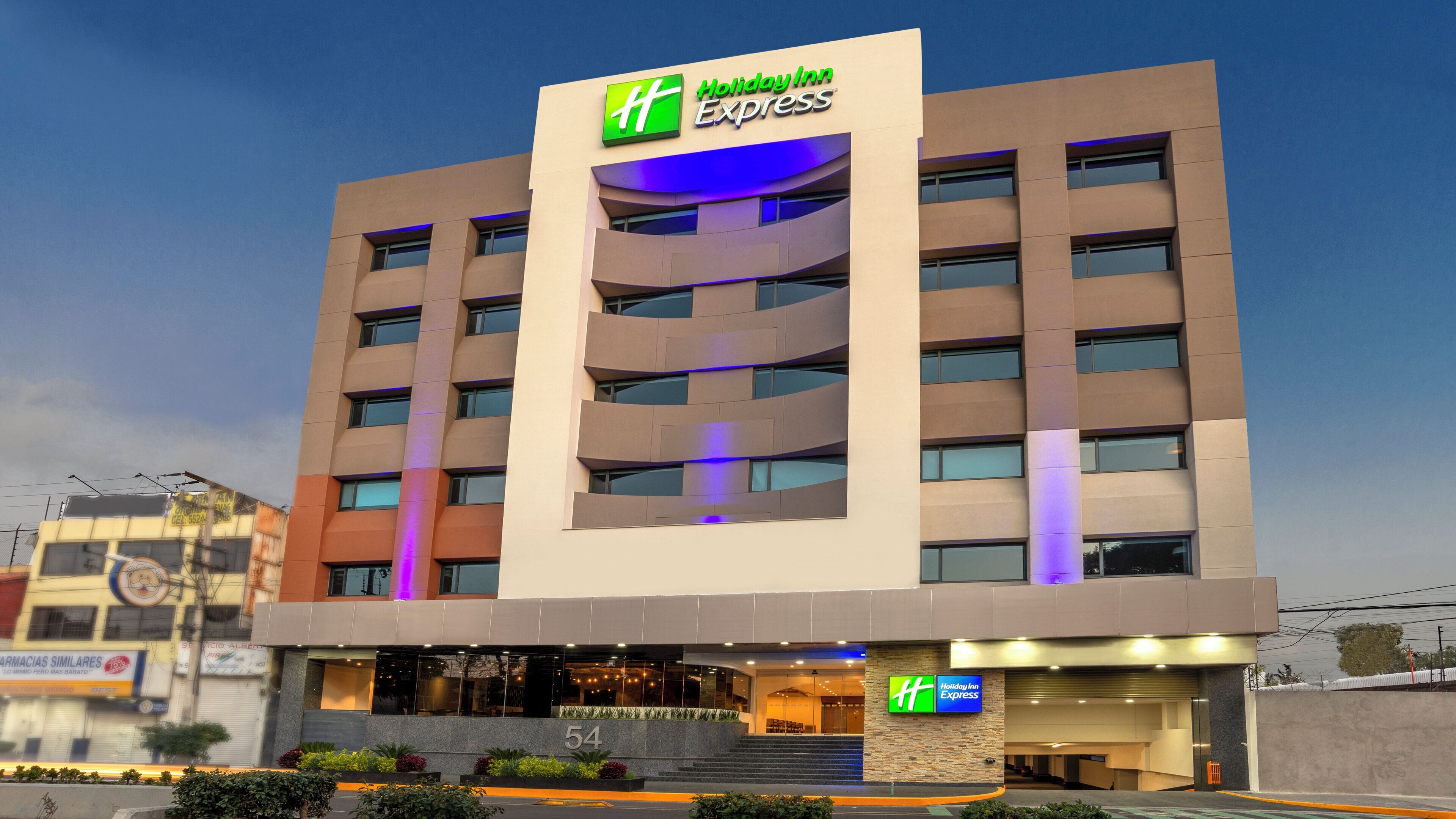 A Holiday Inn Express hotel with a modern design, featuring a prominent 'Holiday Inn Express' sign at the top.