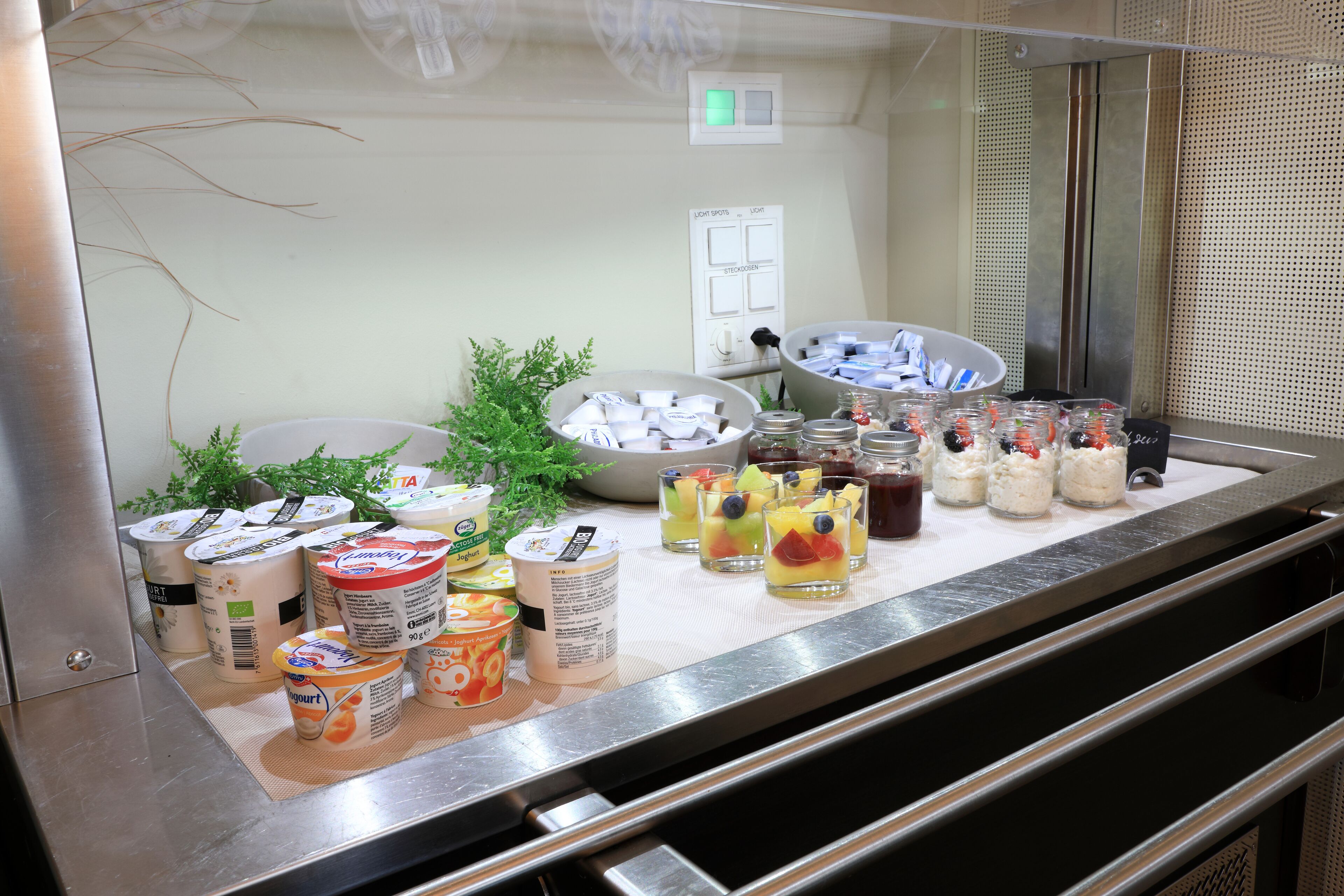 A buffet setup with various food items and beverages.