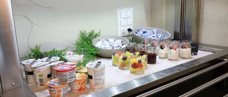 A buffet setup with various food items and beverages.