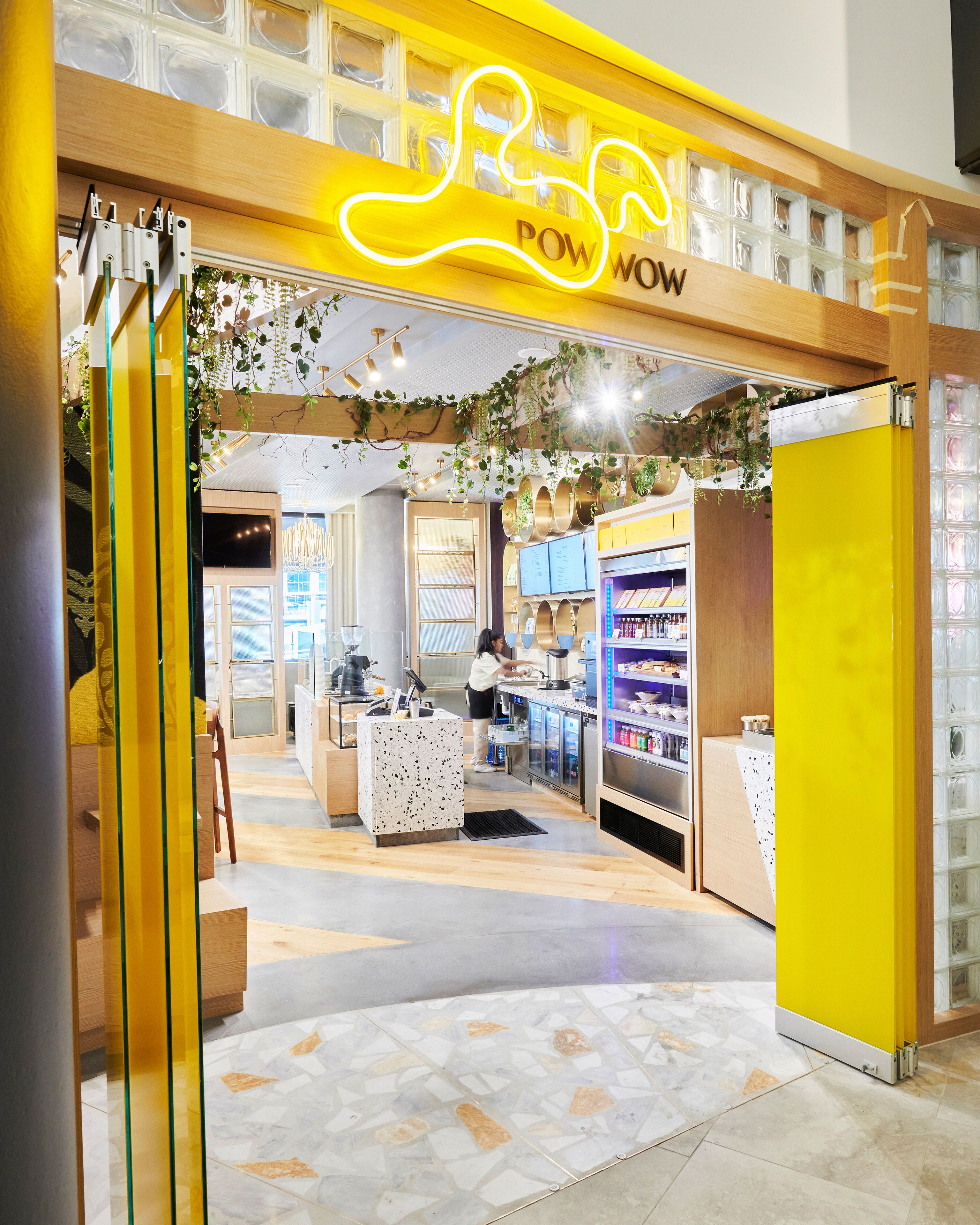 A brightly lit store with a neon sign reading "POW POW POW".