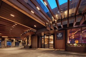 A modern building entrance with a glass facade, wooden paneling, and a sign for Crowne Plaza. - Crowne Plaza Melbourne by IHG (Docklands)
