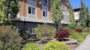 A multi-story building with a modern architectural design, featuring a mix of balconies and windows.