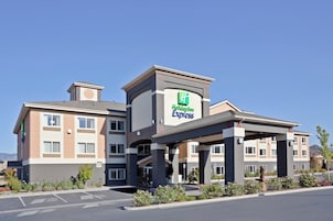 A Holiday Inn Express hotel with a modern design, featuring a prominent entrance and a parking lot.