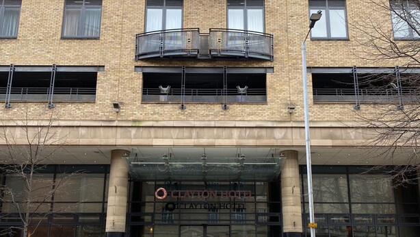 A multi-story hotel with a brick facade, large windows, and a prominent entrance.