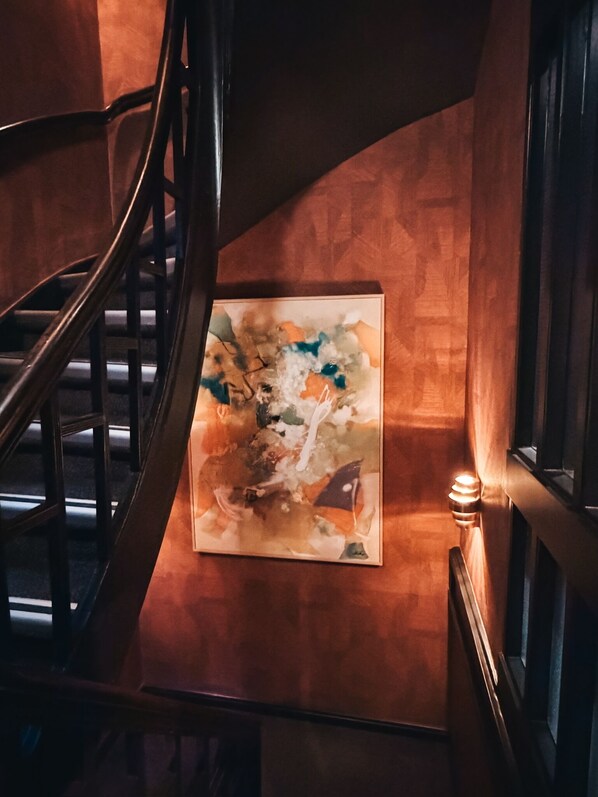 A staircase with a handrail and a wall-mounted abstract painting. - Hotel Damsquare  (Amsterdam)