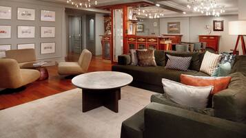 A modern living room with a round coffee table, sofas, and a fireplace.
