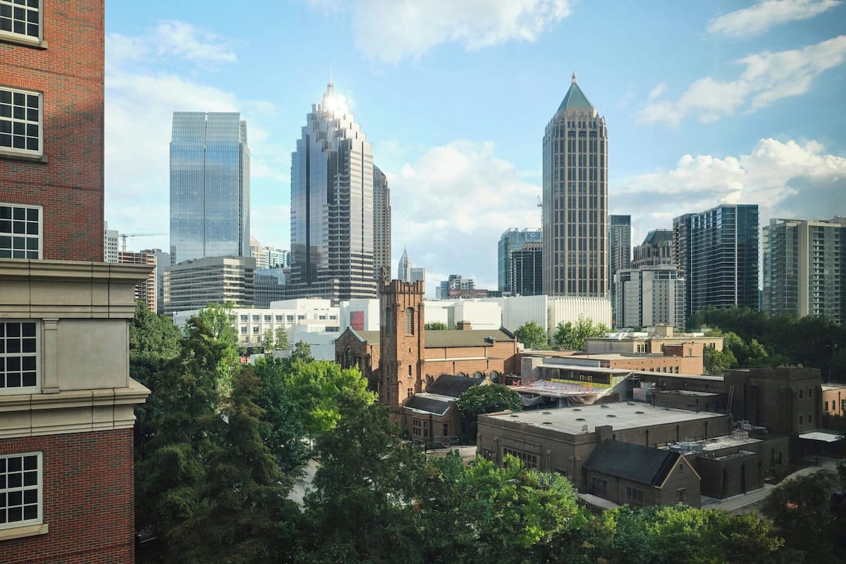 A cityscape with modern skyscrapers and older buildings, including a church.