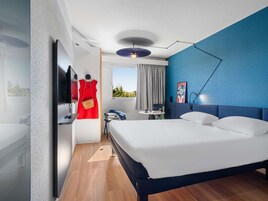 Premium bedding, desk, laptop workspace, blackout drapes