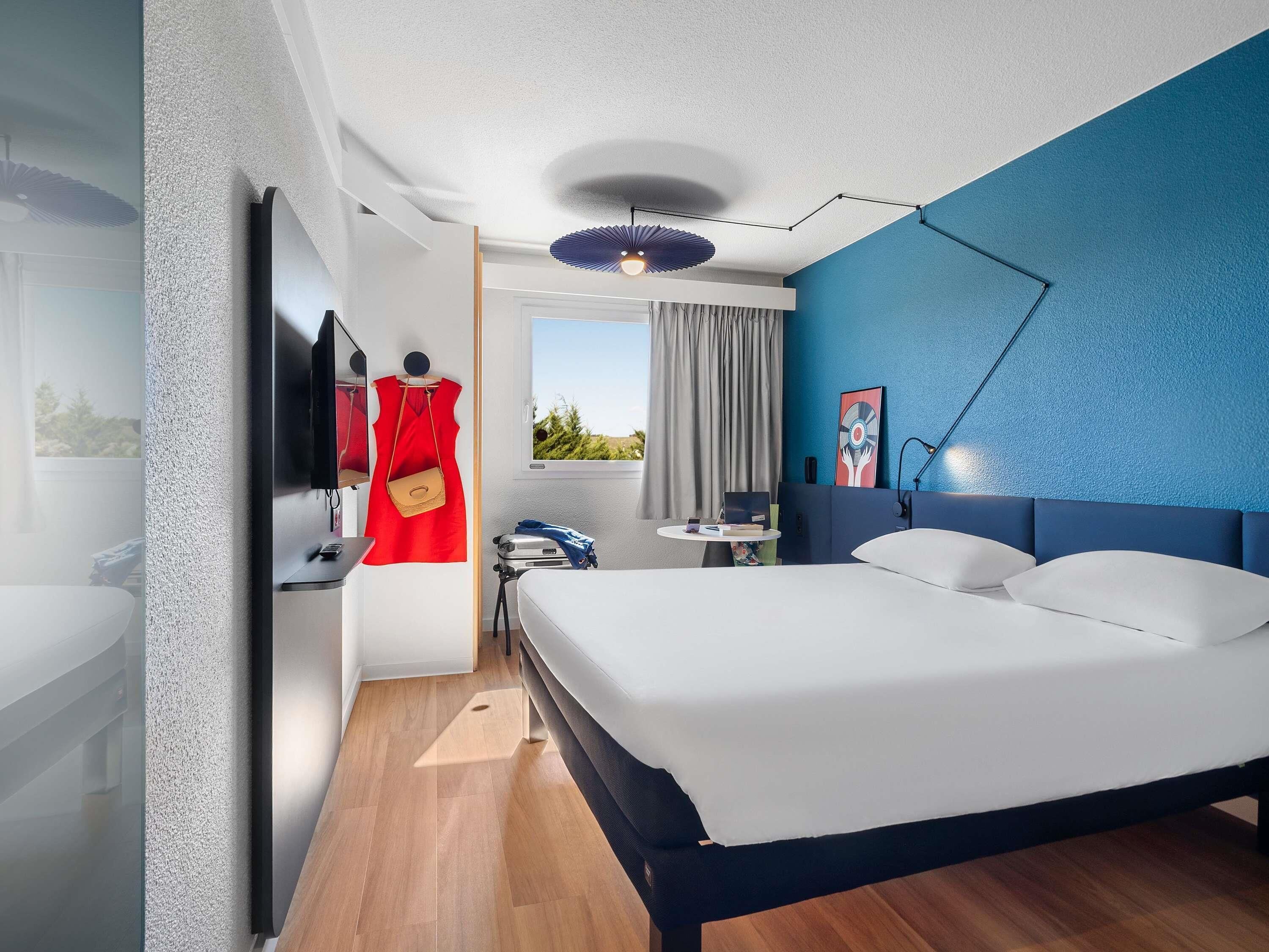 Premium bedding, desk, laptop workspace, blackout drapes