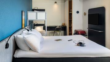 Premium bedding, desk, laptop workspace, blackout drapes
