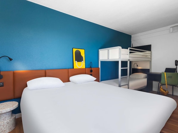 Premium bedding, desk, laptop workspace, blackout drapes