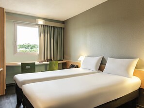 Premium bedding, desk, laptop workspace, blackout drapes