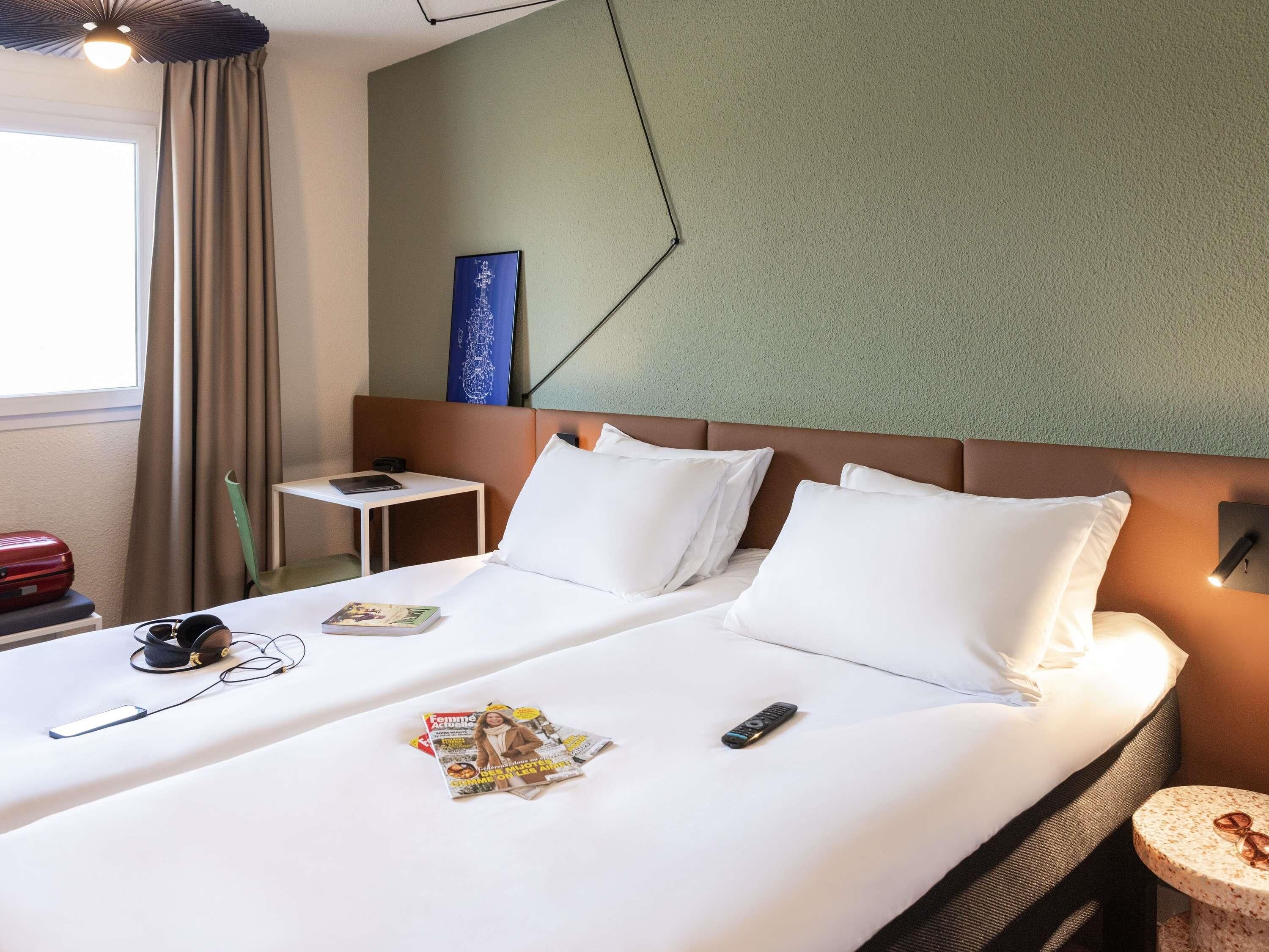 Premium bedding, desk, laptop workspace, blackout drapes