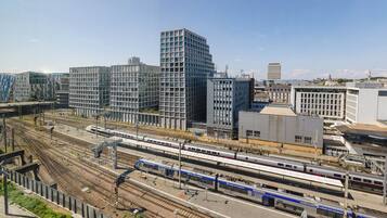 A modern urban area with multiple train tracks and high-rise buildings.