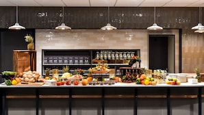 A buffet setup with various fruits, vegetables, and beverages. - Scandic Star (Lund)