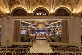 A poker room with a large sign, multiple gaming tables, and a polished marble floor. at Green Valley Ranch Resort and Spa
