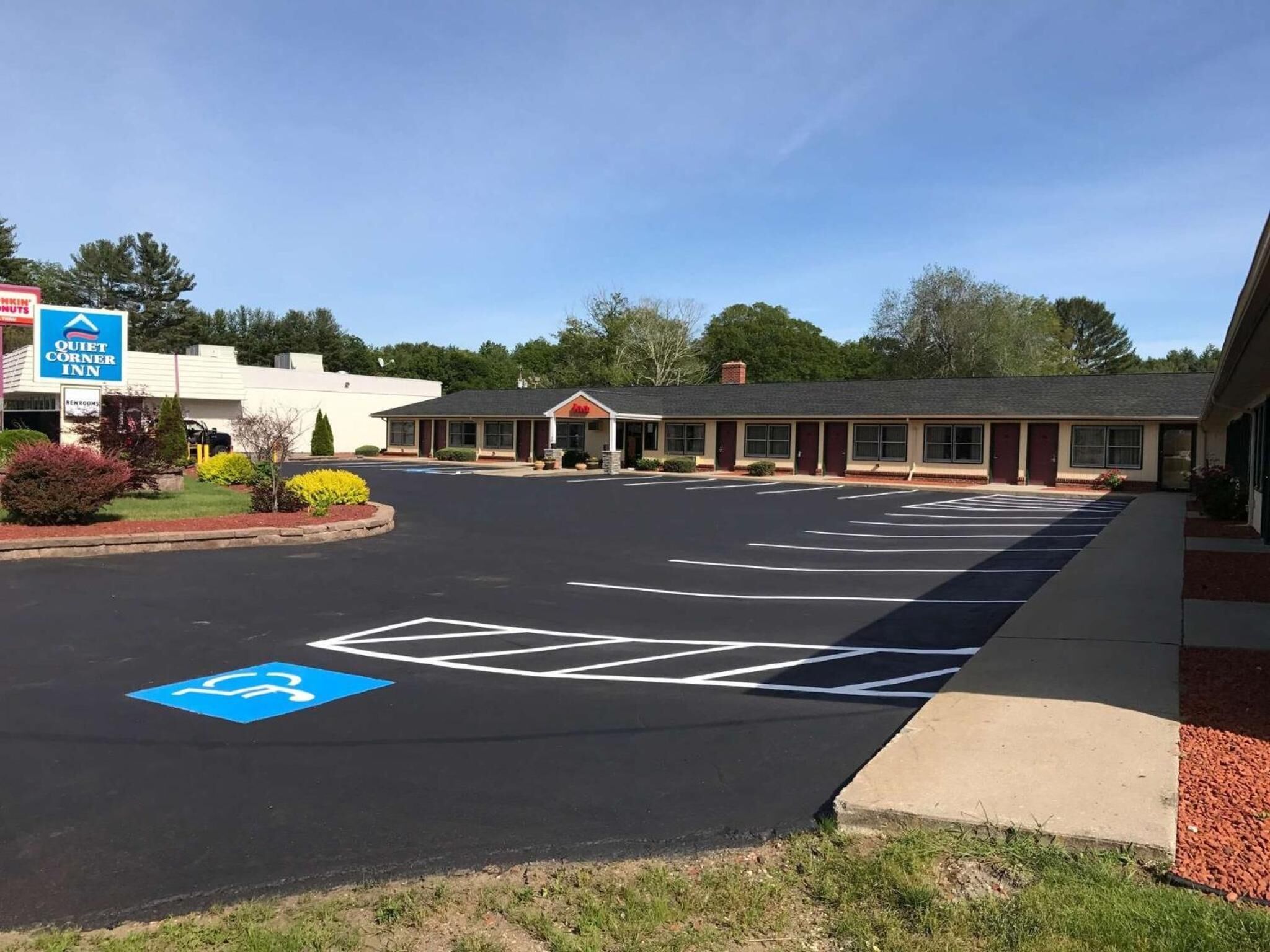 A Quiet Corner Inn with a parking lot marked for handicapped access.