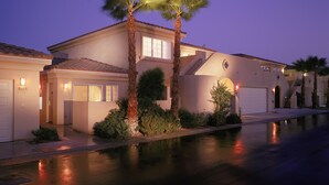 A two-story house with a garage, a covered patio, and a well-maintained lawn. - Raintree's Cimarron Golf Resort (Cathedral City)