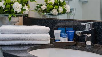 Shower, designer toiletries, hair dryer, slippers