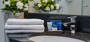 Shower, designer toiletries, hair dryer, slippers