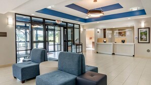 A spacious lobby with a reception desk, seating area, and large windows offering a view of the outdoors. - Comfort Inn & Suites Troutville-Roanoke North (Troutville)