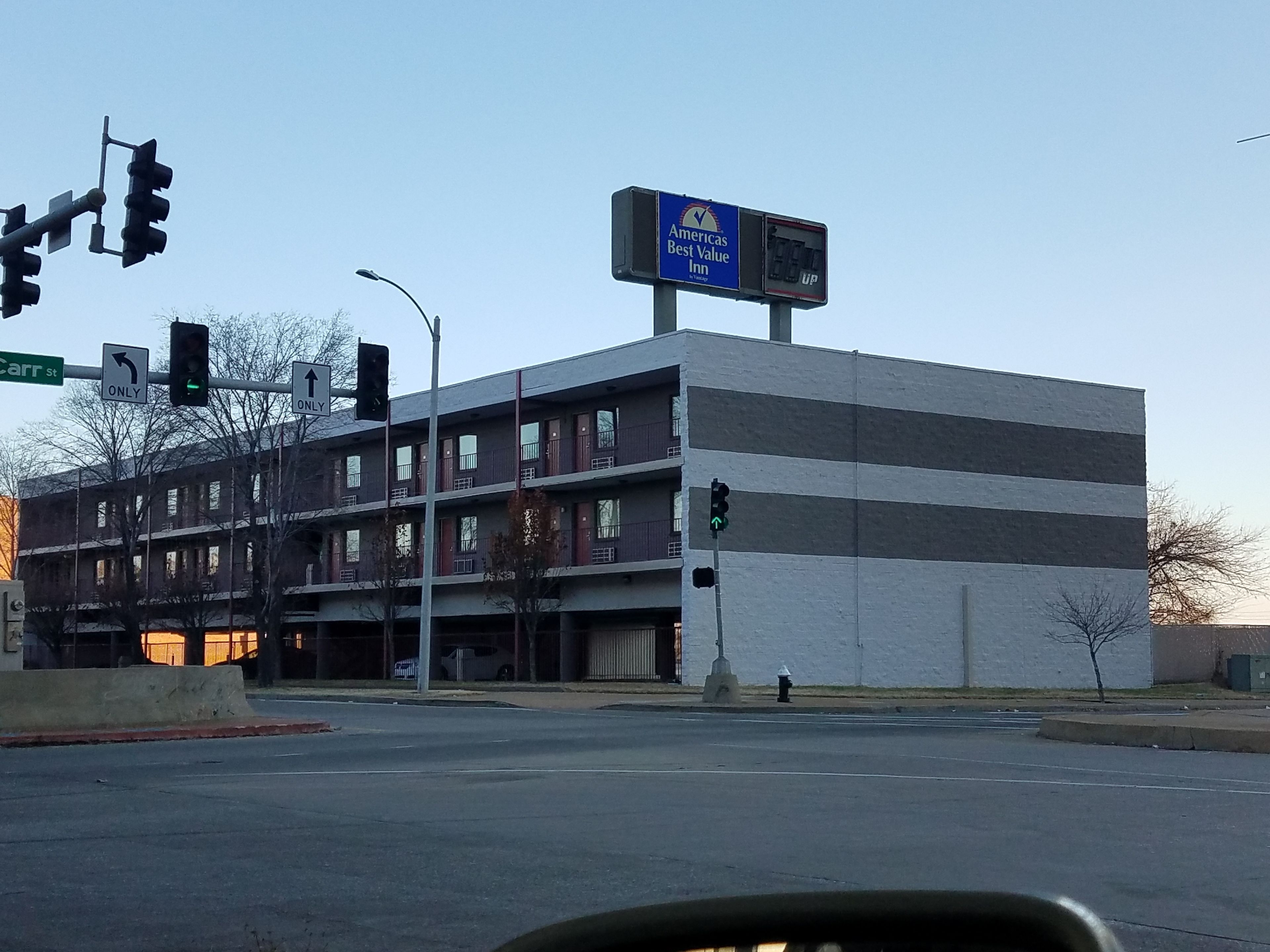 A multi-story building with a sign for America's Best Value Inn.