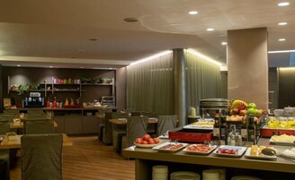 A buffet area with various food items and a bar with beverages.