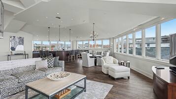 Un amplio salón con un gran ventanal, una cocina y un comedor.