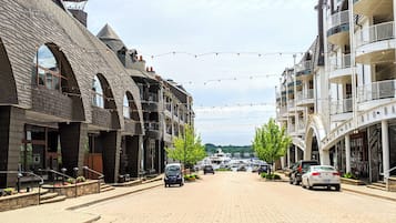 A street lined with multi-story buildings featuring arched windows and balconies.