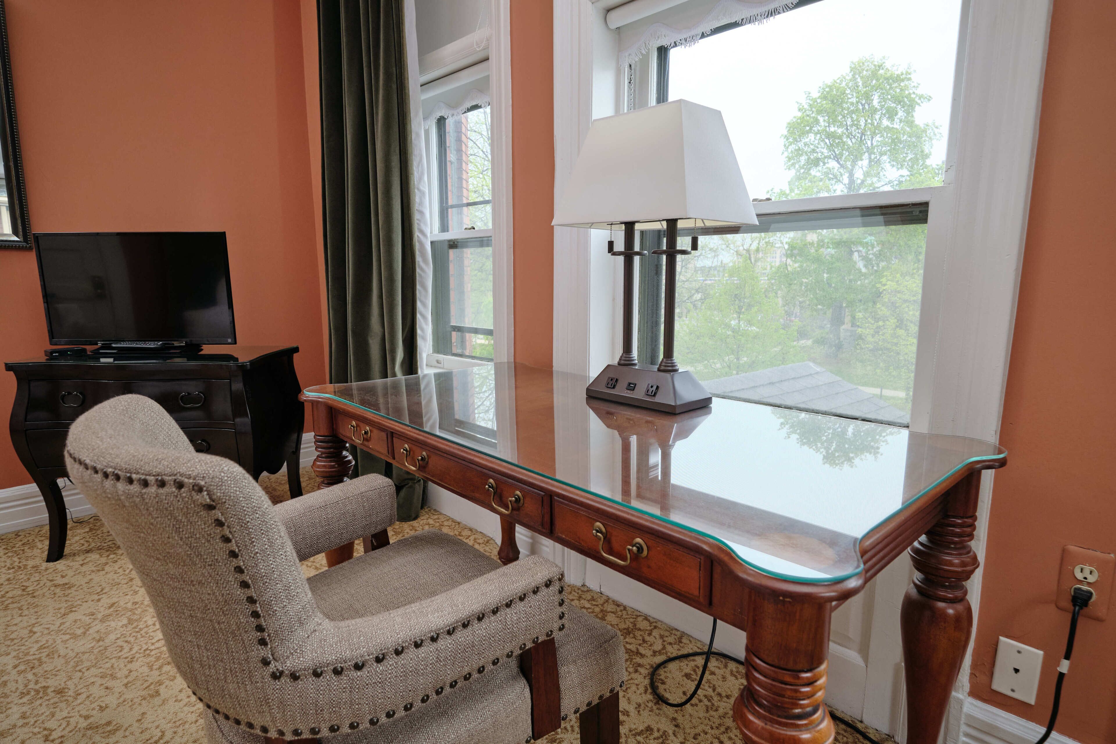 premium room, 2 queen beds | living area | flat-screen tv, books, stereo