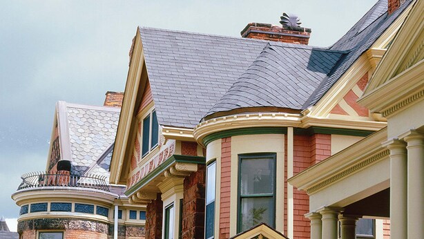 A row of Victorian-style houses with distinct architectural features such as ornate gables, brick facades, and decorative trim.